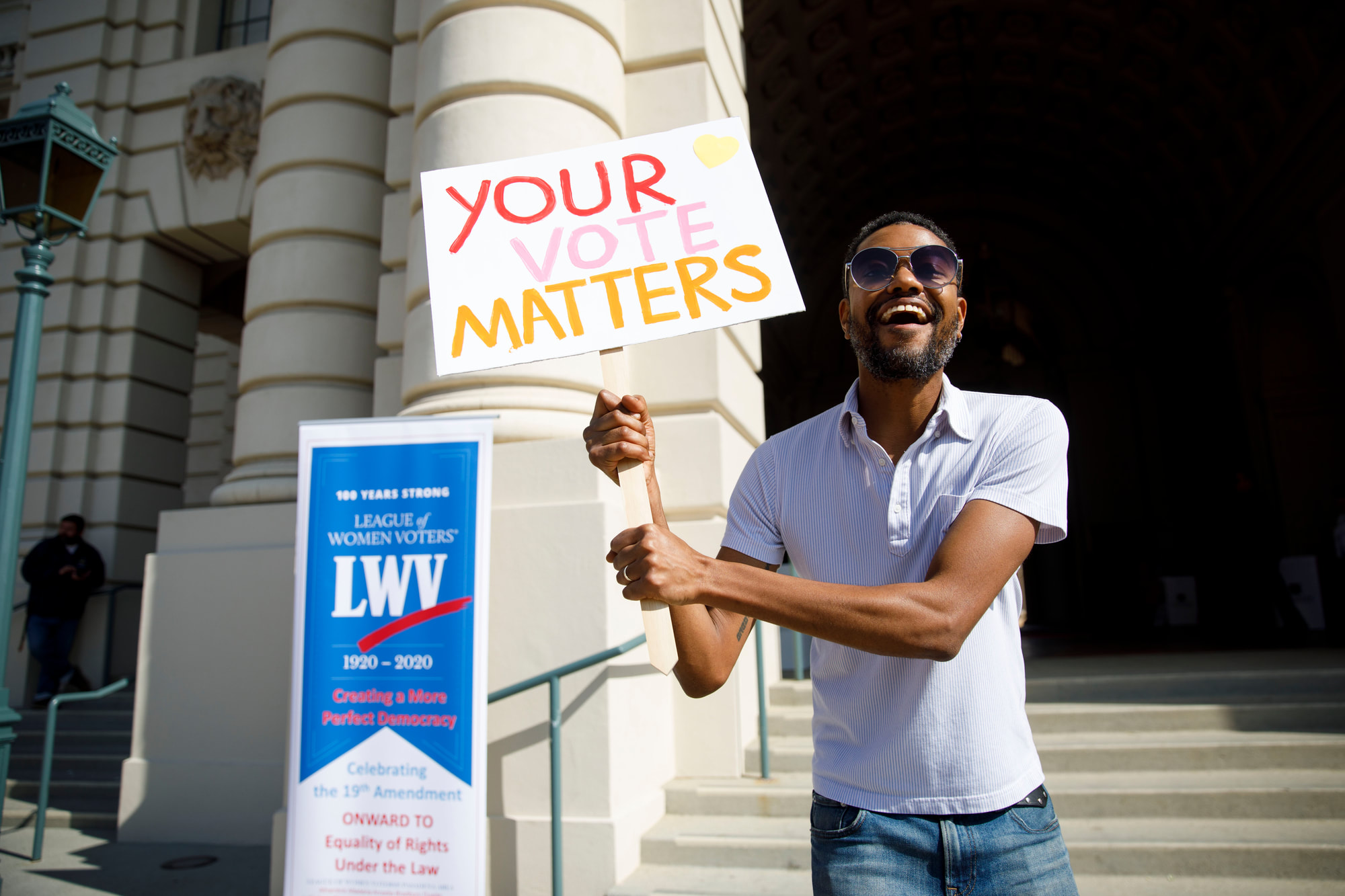 A person with sign saying your vote matters